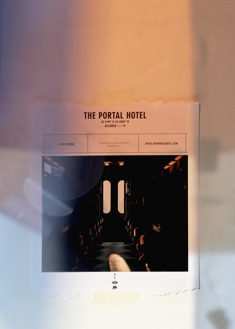 The Portal Hotel poster taped to a wall showing the train corridor interior and project branding